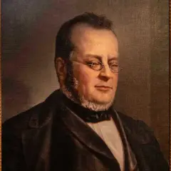 Ritratto di Michele Benso di Cavour, con occhiali tondi e barba curata, vestito elegantemente.
