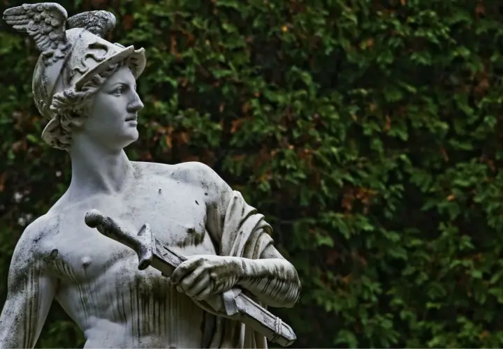Statua di Hermes con elmo alato e spada, simbolo di messaggero e commercio. Il suo significato è legato alla velocità e all'ingegno.