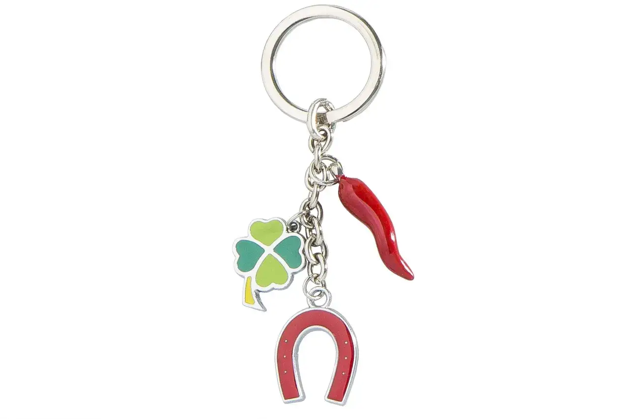 Portachiavi con quadrifoglio, cornetto rosso e ferro di cavallo, un vero emblema della fortuna.