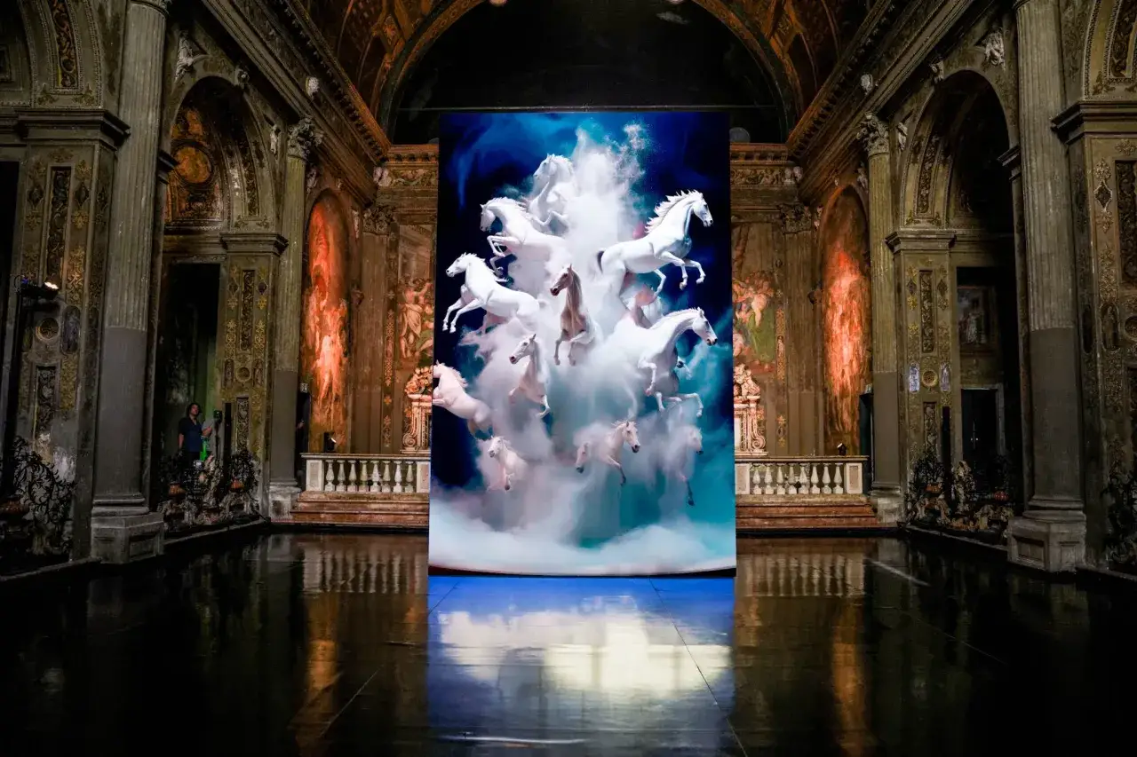 Cavalli bianchi in volo su uno schermo digitale all'interno di San Paolo Converso, Milano.